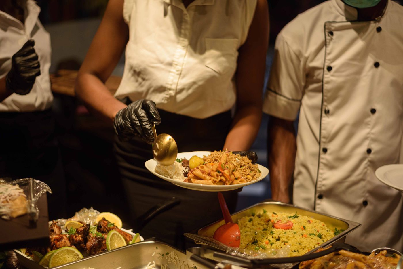 Caterers serving guests at a buffet